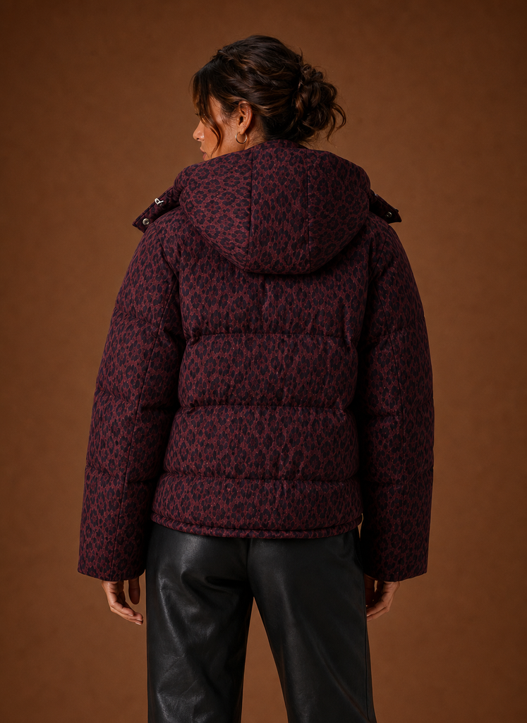 Back view of women's leopard puffer jacket showing quilted pattern and coverage