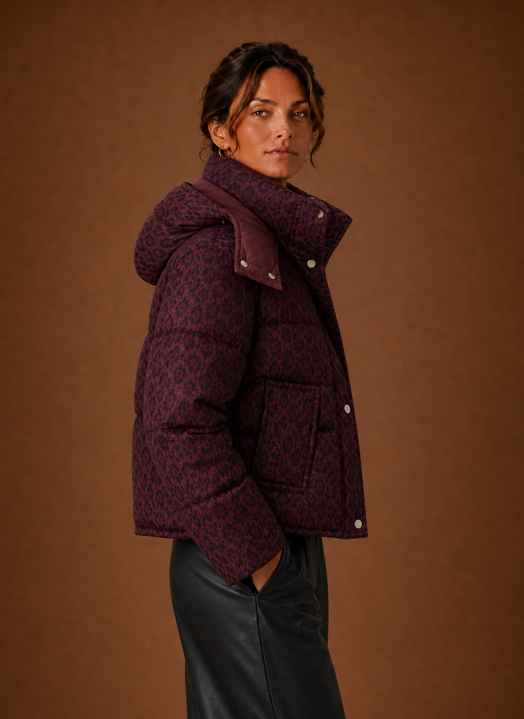 Side view of women's leopard puffer jacket in burgundy highlighting profile and fit